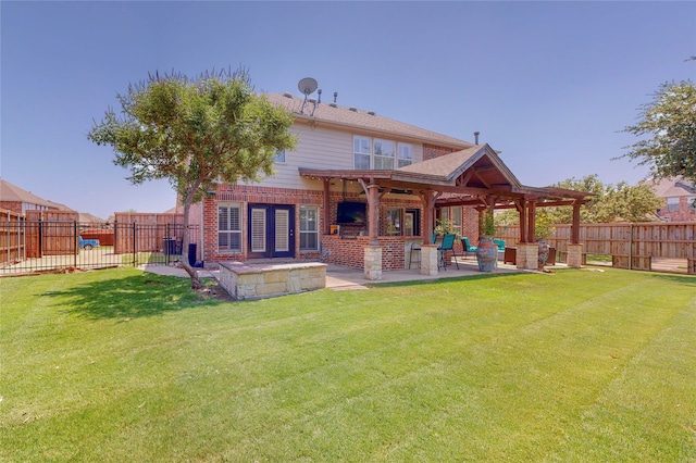 rear view of house with a yard and a patio