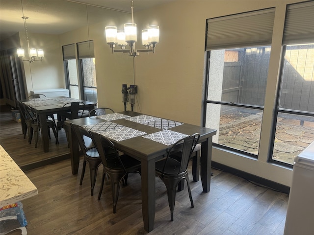 dining space featuring a chandelier, plenty of natural light, and dark wood-type flooring