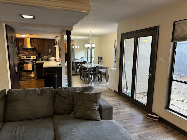 living room with an inviting chandelier and hardwood / wood-style floors