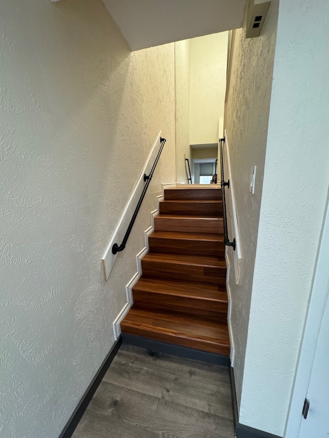 staircase with hardwood / wood-style flooring