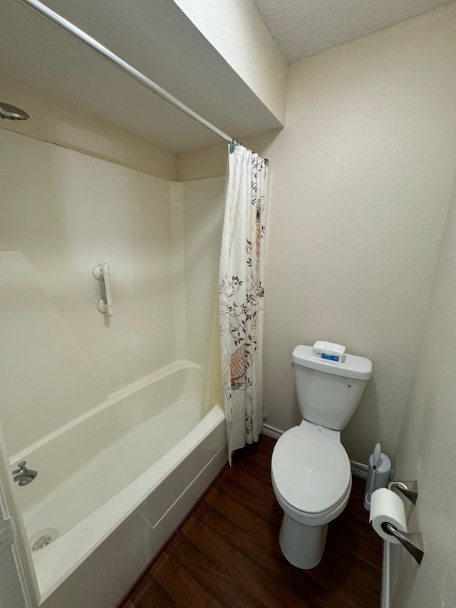 bathroom featuring wood-type flooring, shower / bathtub combination with curtain, and toilet