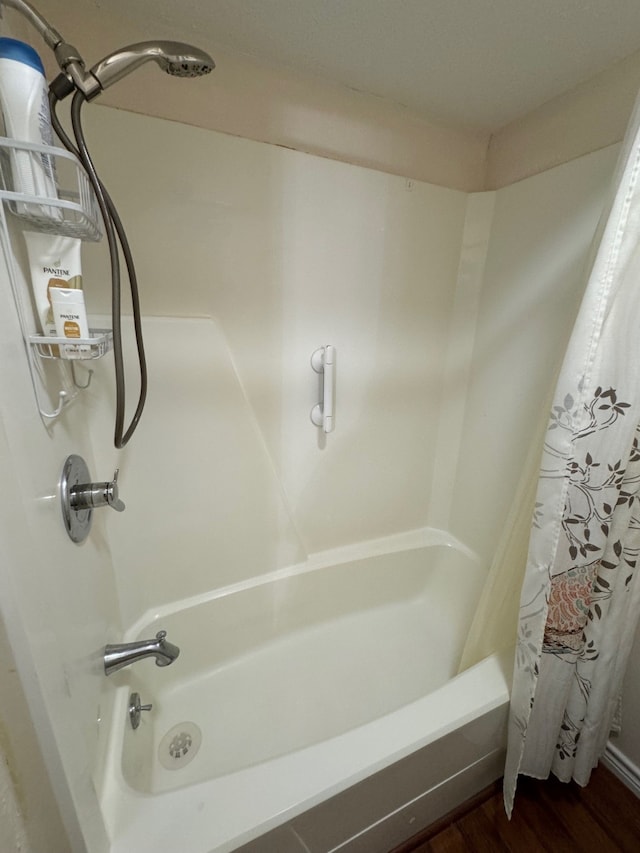 bathroom featuring hardwood / wood-style floors and shower / bath combination with curtain