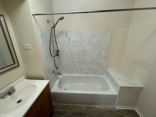 bathroom featuring vanity, hardwood / wood-style flooring, and tiled shower / bath