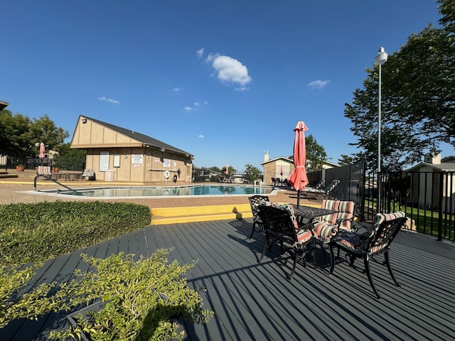 wooden terrace featuring a community pool