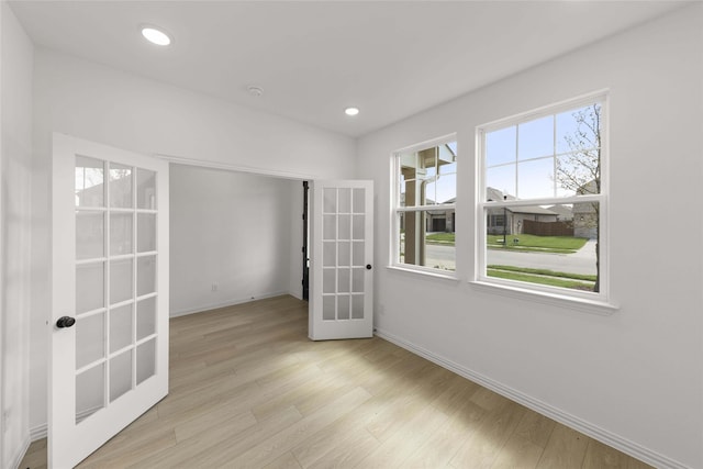 unfurnished room featuring light hardwood / wood-style flooring and french doors