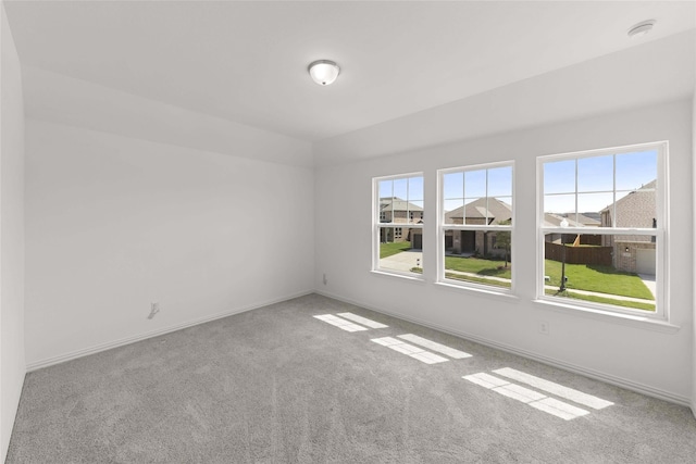 empty room with lofted ceiling and light carpet