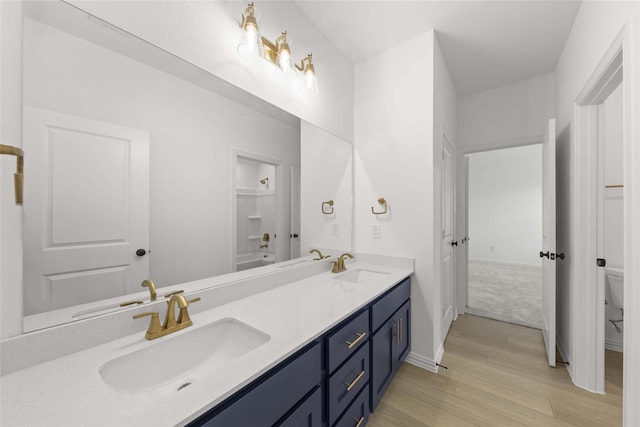 bathroom with vanity, wood-type flooring, and toilet