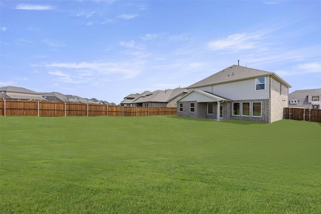 back of house featuring a yard