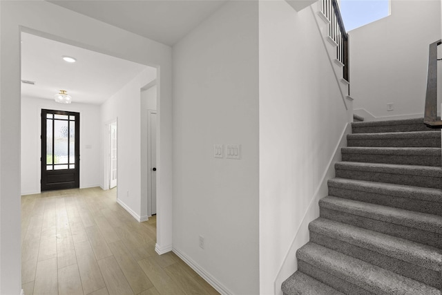 stairway featuring hardwood / wood-style floors