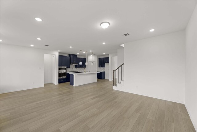 unfurnished living room featuring light hardwood / wood-style flooring