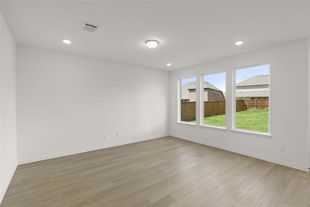 spare room featuring light hardwood / wood-style flooring