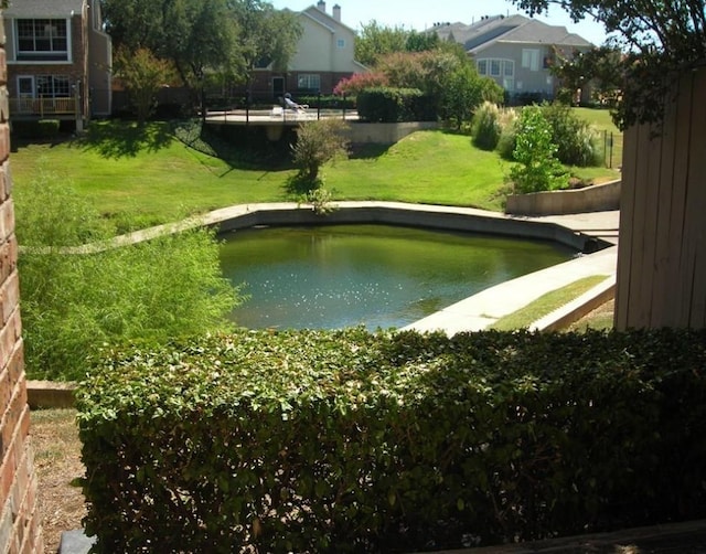 view of home's community featuring a water view and a yard