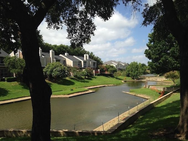 view of community with a water view and a lawn