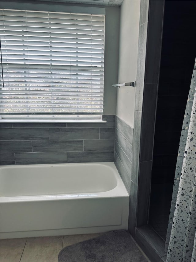 bathroom featuring shower with separate bathtub and tile patterned flooring