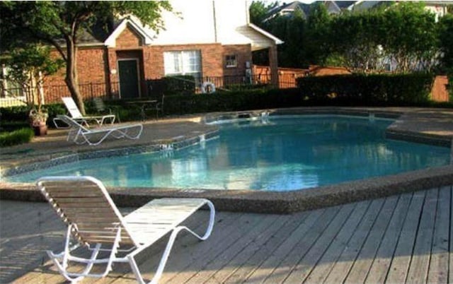 view of swimming pool with a deck