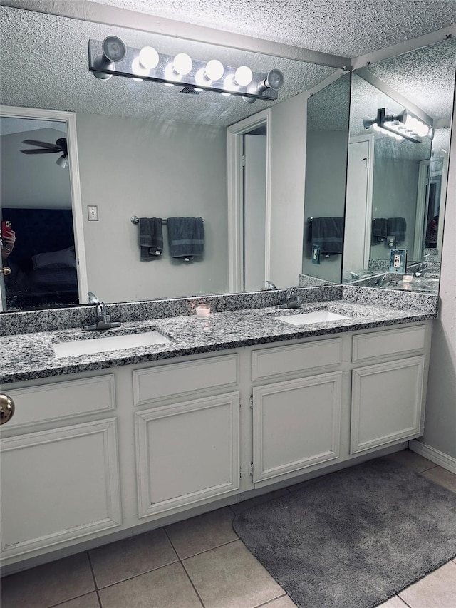 bathroom with vanity, a textured ceiling, tile patterned floors, and ceiling fan