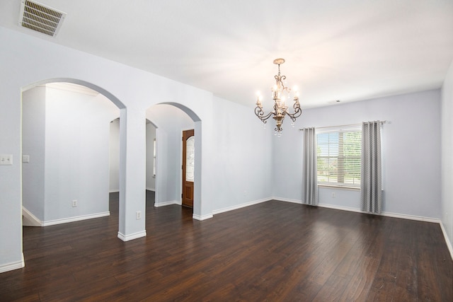 unfurnished room featuring dark wood-type flooring and a chandelier