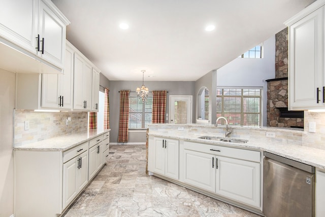 kitchen with pendant lighting, white cabinets, sink, and stainless steel dishwasher