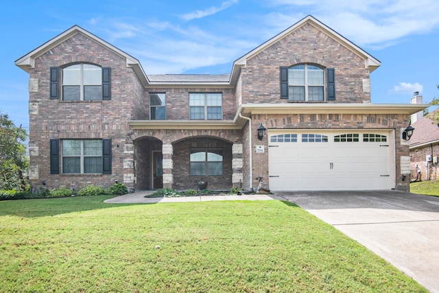 view of front of house featuring a garage and a front lawn