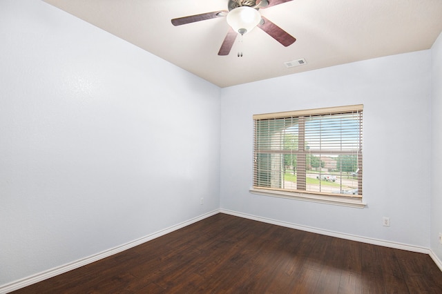 empty room with dark wood-type flooring and ceiling fan