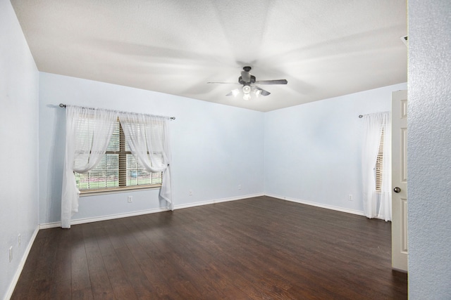 empty room with ceiling fan, a textured ceiling, and dark hardwood / wood-style flooring