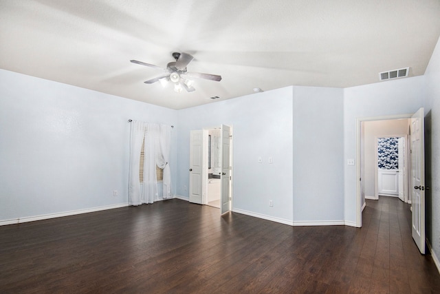 empty room featuring ceiling fan and dark wood-type flooring