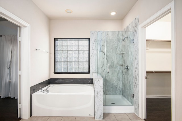 bathroom featuring independent shower and bath and tile patterned flooring