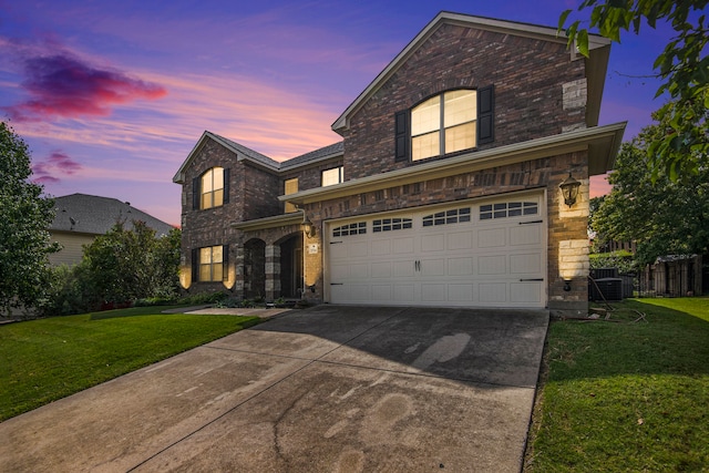 view of front of home featuring a garage and a yard