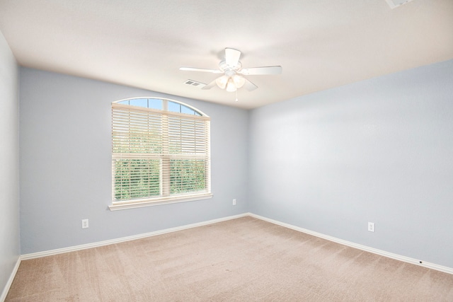 spare room featuring ceiling fan and carpet flooring