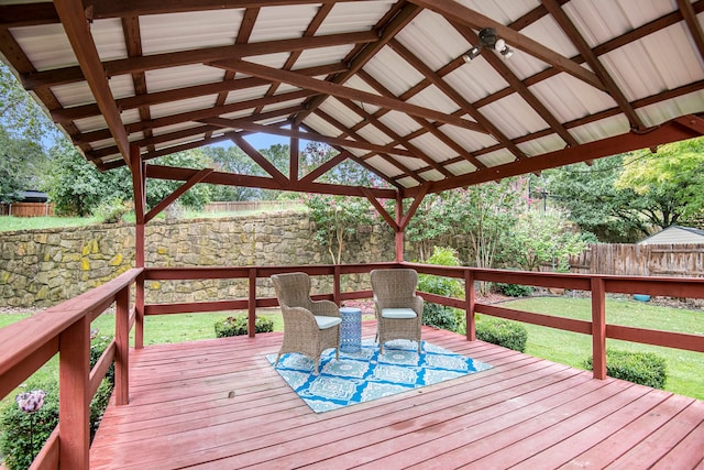 wooden terrace featuring a gazebo and a lawn