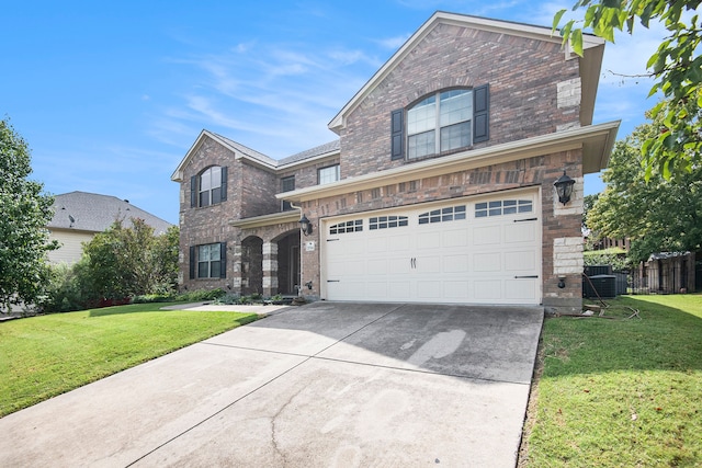 view of property featuring a front lawn and a garage