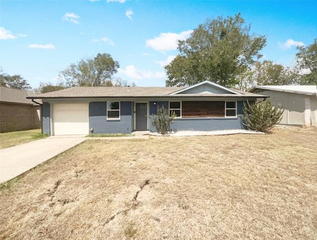 single story home featuring a garage and a front yard