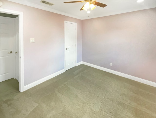 carpeted empty room with ornamental molding and ceiling fan