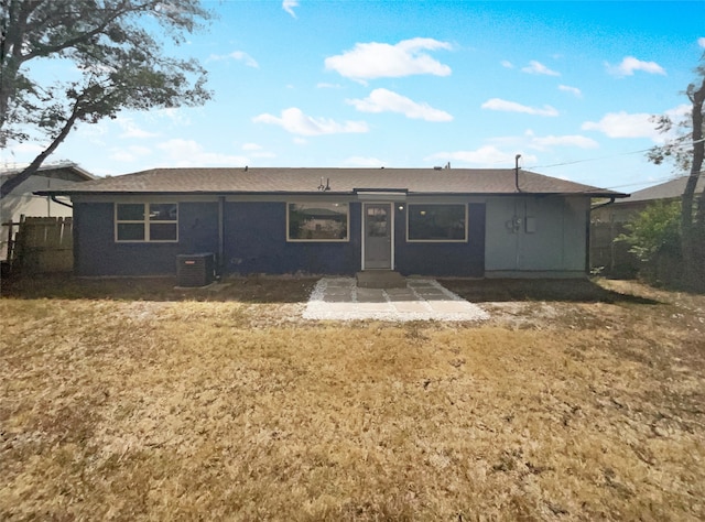 rear view of property with a patio, a yard, and central AC unit