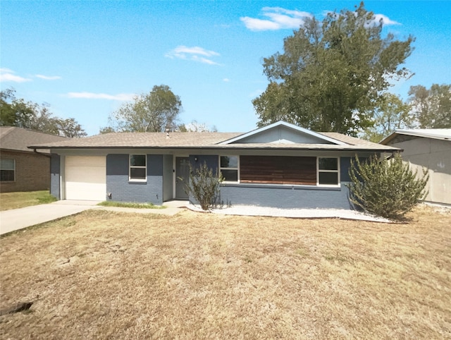 ranch-style home with a garage and a front lawn