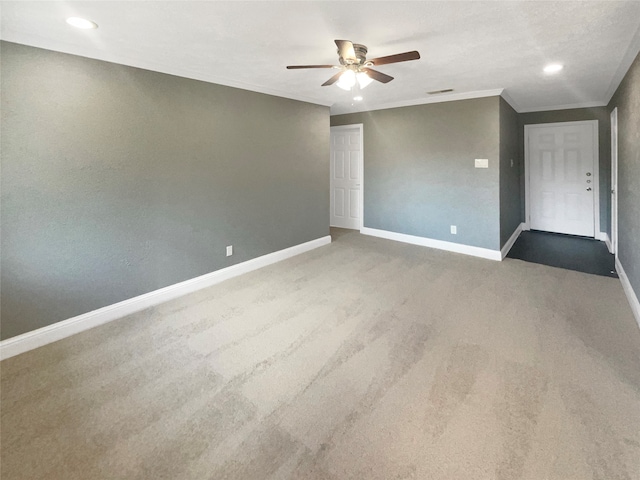 unfurnished room featuring ceiling fan, carpet flooring, and crown molding