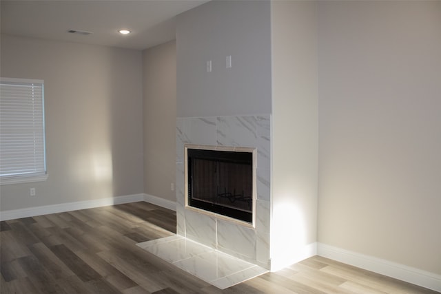 unfurnished living room with hardwood / wood-style flooring and a fireplace