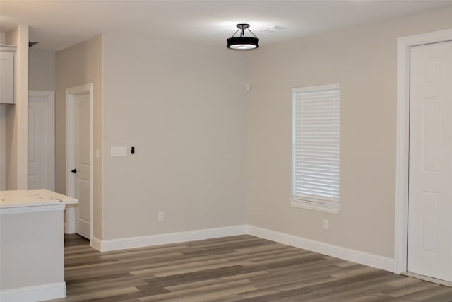 unfurnished room with dark hardwood / wood-style flooring