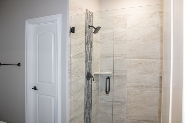 bathroom with a shower with shower door