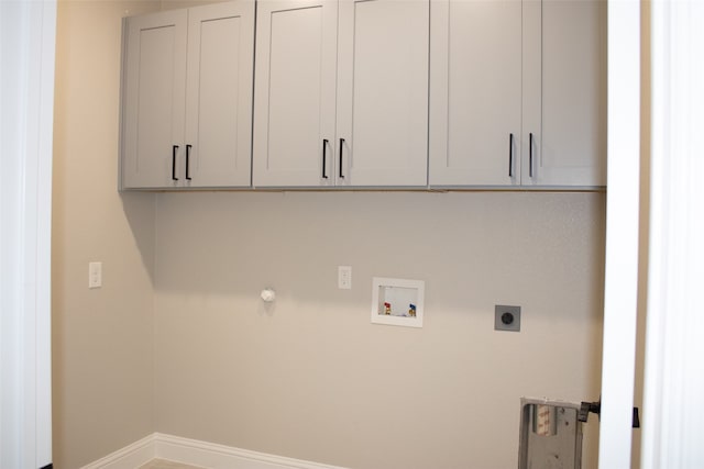 laundry room featuring hookup for a washing machine, cabinets, gas dryer hookup, and hookup for an electric dryer