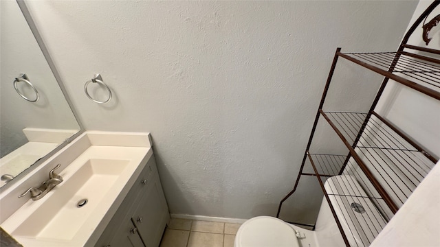 bathroom featuring vanity, toilet, and tile patterned floors