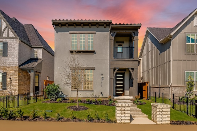 13638 Colony Mews, Frisco, TX 75033 - view of front of house with a front yard, fence, stucco siding, and a balcony
