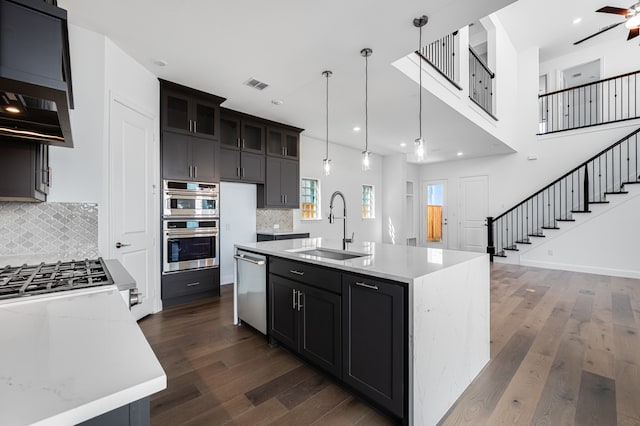 13638 Colony Mews, Frisco, TX 75033 - kitchen featuring dark wood finished floors, visible vents, decorative backsplash, stainless steel appliances, and a sink