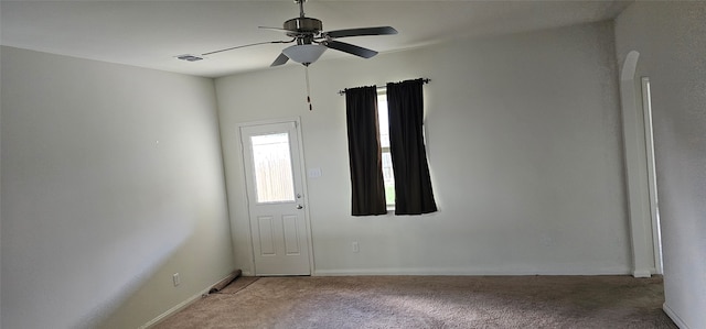 carpeted spare room with ceiling fan