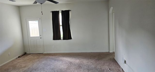 carpeted spare room with ceiling fan