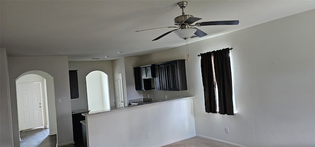 kitchen featuring carpet floors, light stone countertops, and ceiling fan