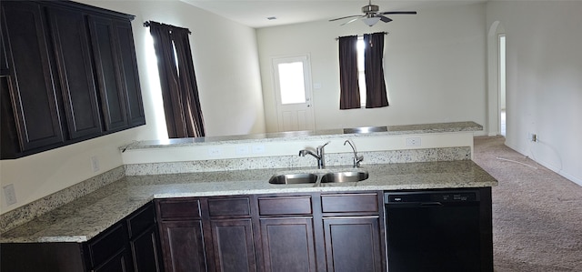 kitchen featuring dishwasher, dark brown cabinets, ceiling fan, sink, and light colored carpet