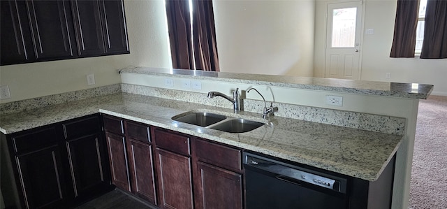 kitchen featuring light stone counters, kitchen peninsula, dishwasher, dark colored carpet, and sink