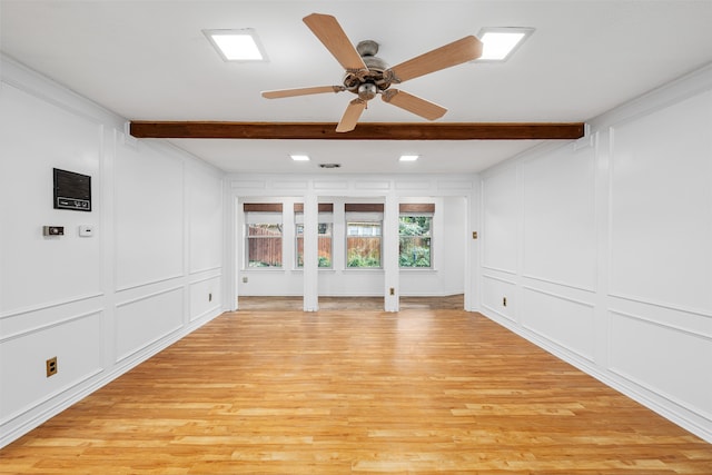 unfurnished living room featuring beam ceiling, light hardwood / wood-style floors, and ceiling fan