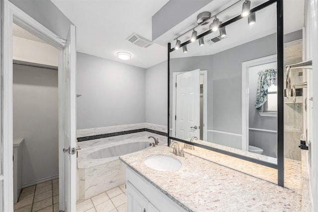 bathroom with vanity, a washtub, and tile patterned floors